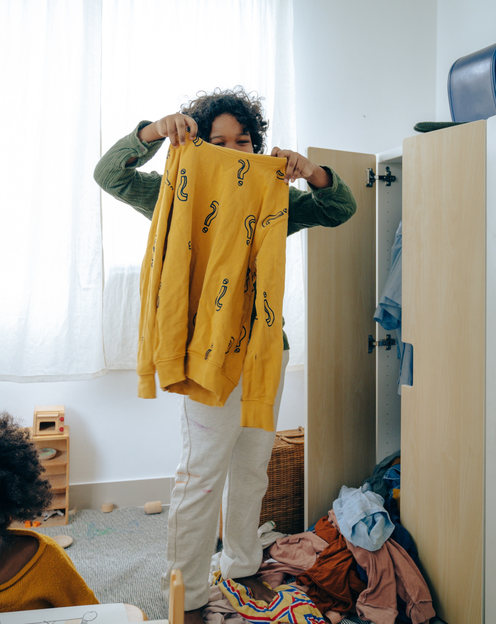 child-holding-clothes